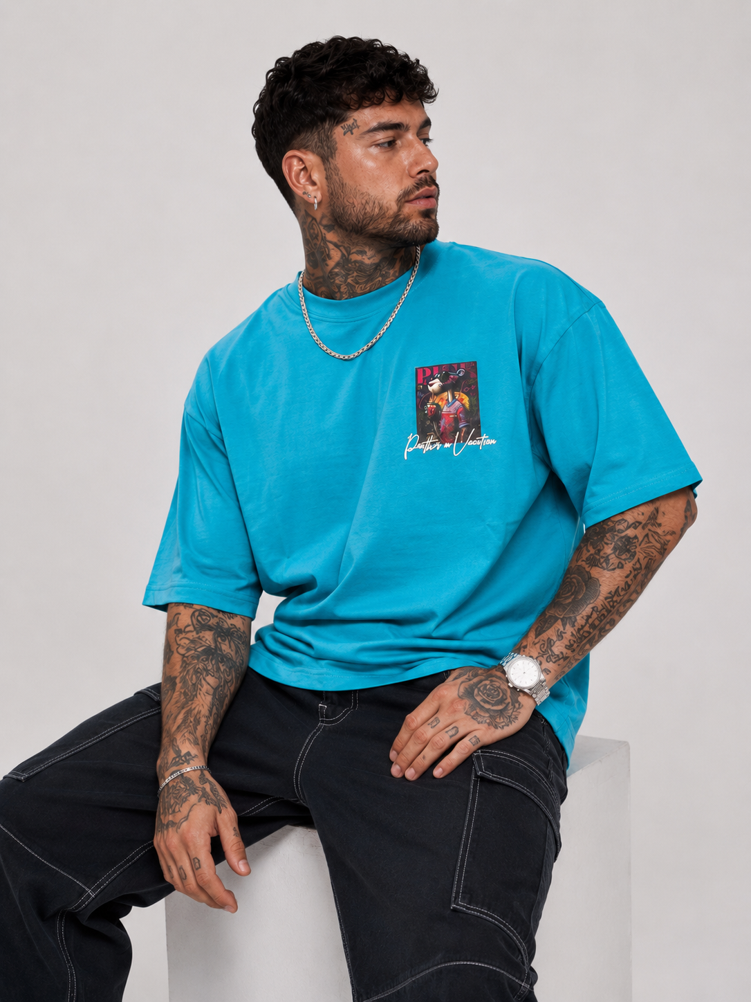 Cerulean blue drop-shoulder graphic shirt with small front graphic