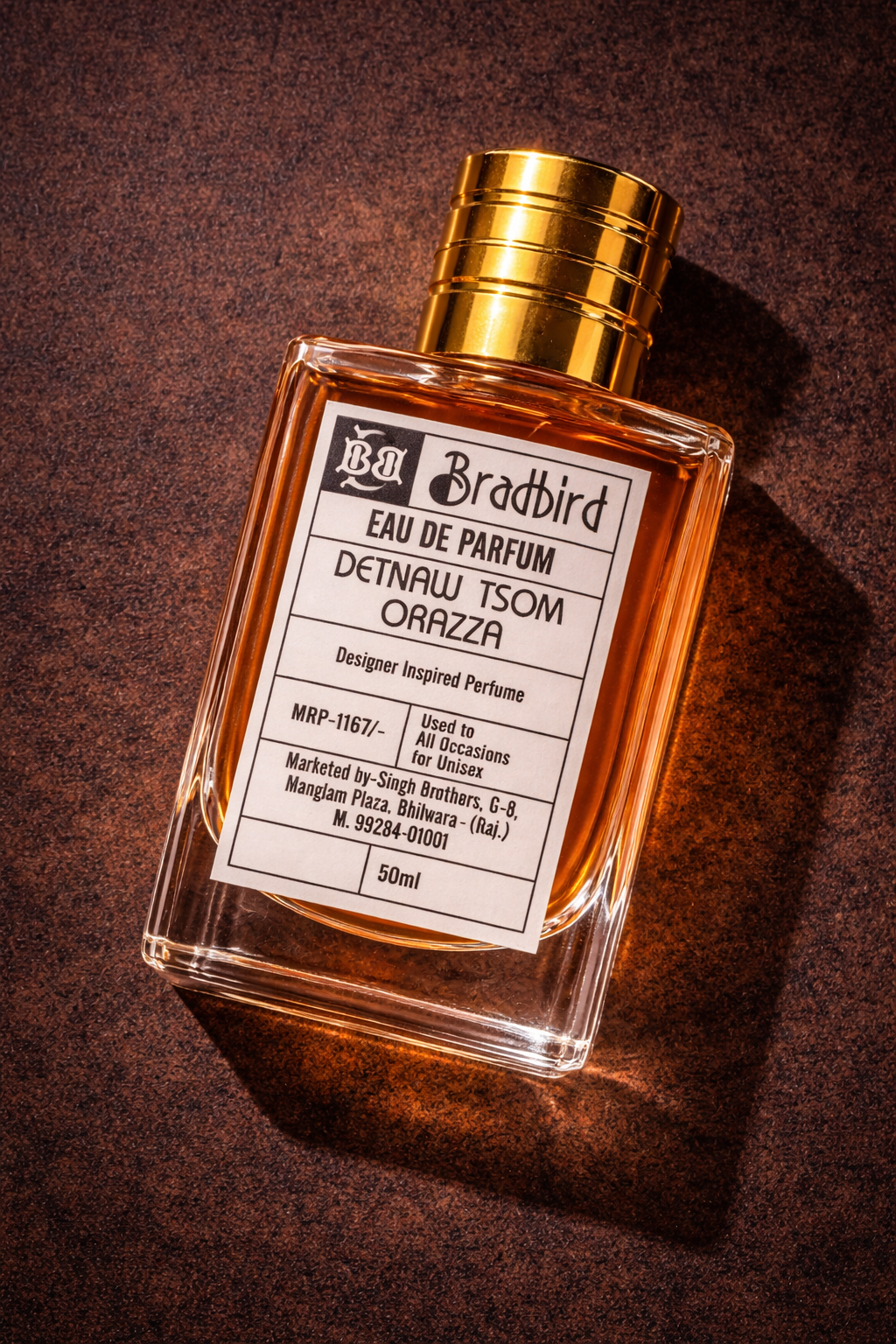 Eau de Parfum bottle with amber glass, gold ribbed cap, label centered on front