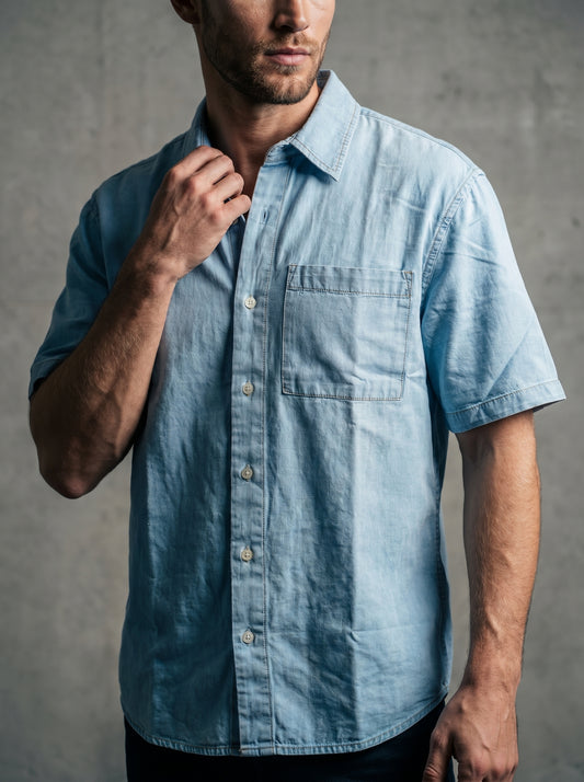 Powder blue denim half-sleeve shirt with open collar, button front, chest pocket