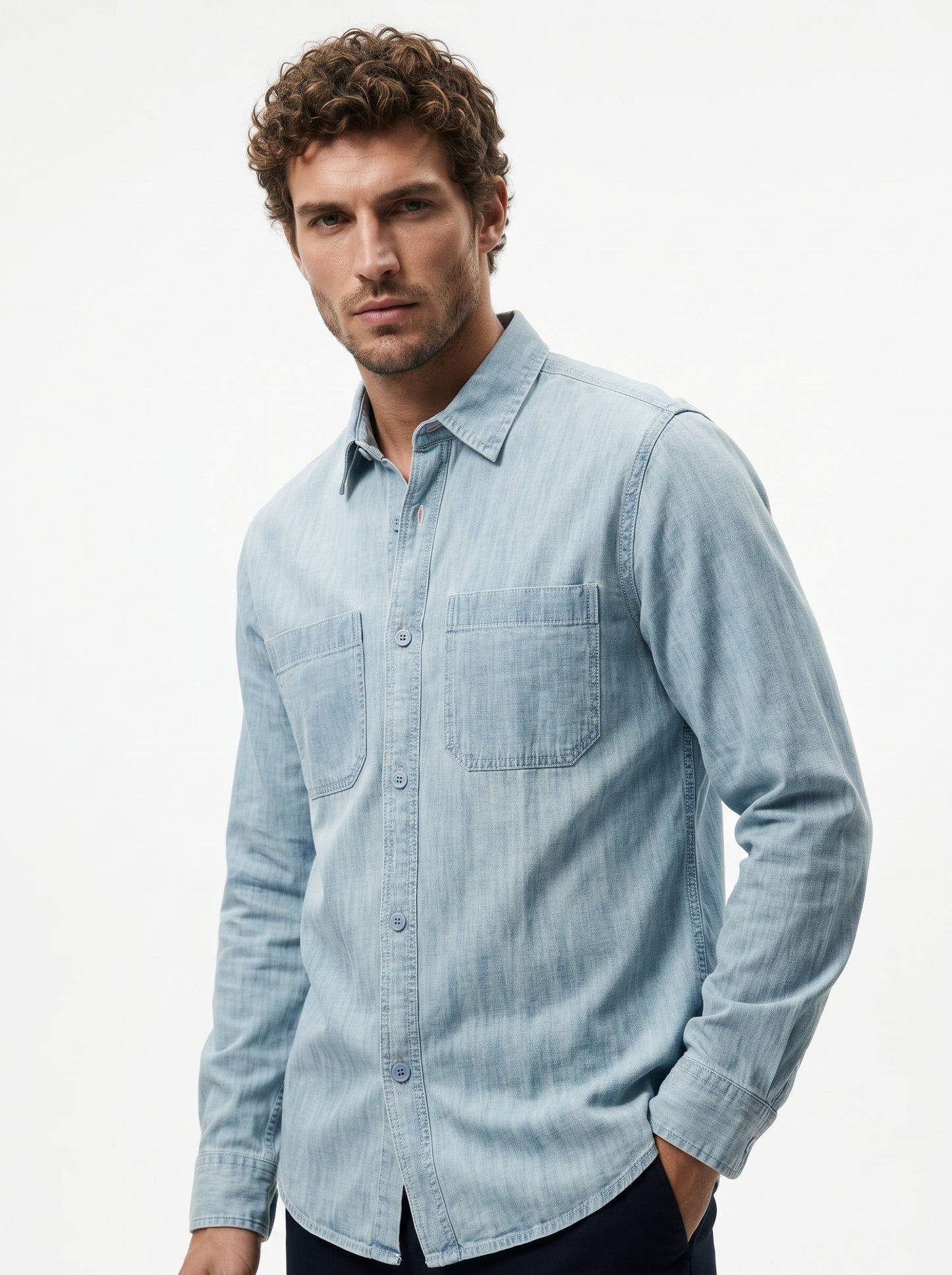 Light blue denim long-sleeve button-up shirt with chest pocket and curved hem