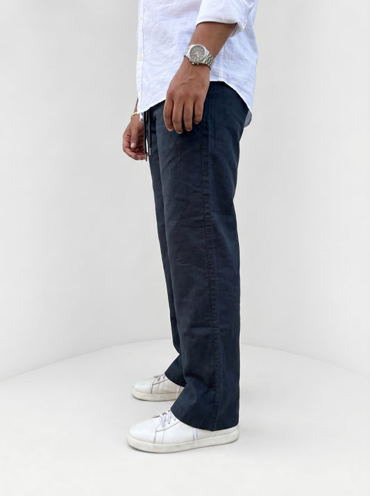 Navy drawstring pants, relaxed fit, front view with pockets and tied waist
