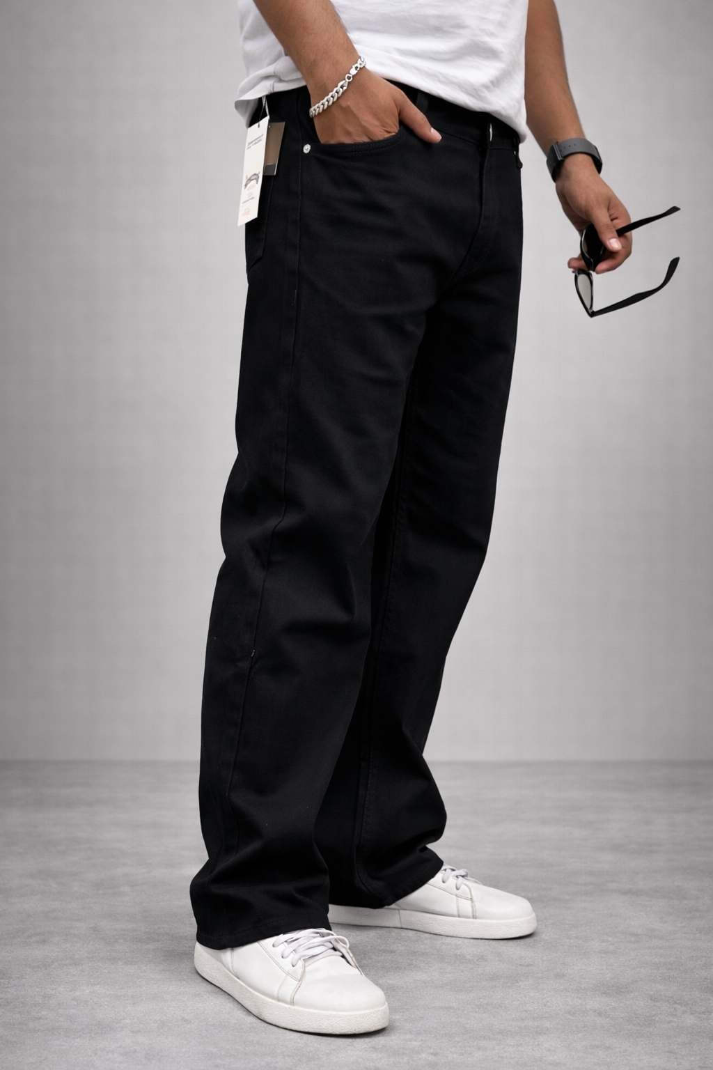 Men's jet black straight-fit jeans, side view with ankle-length hem
