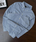 Folded sky blue micro-check button-up shirt with button placket and collar