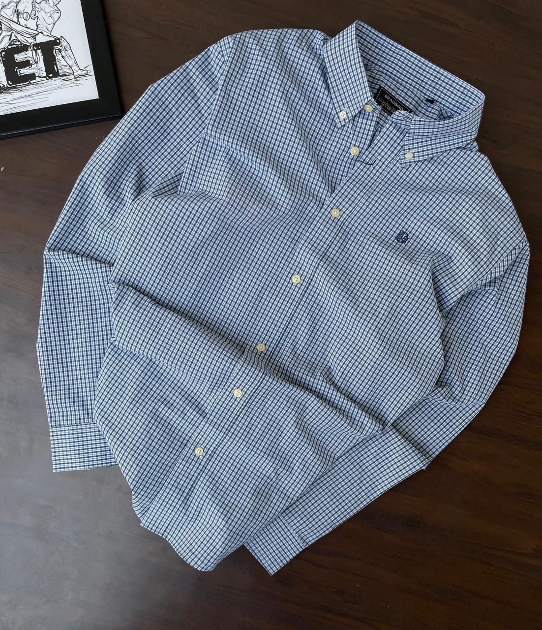 Folded sky blue micro-check button-up shirt with button placket and collar