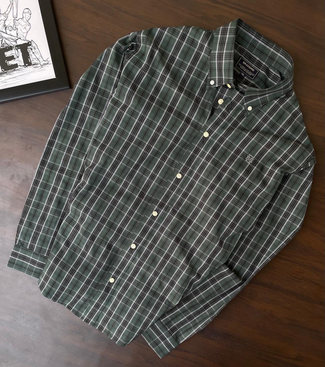 Bottle green tartan check shirt laid flat, full front view, button placket