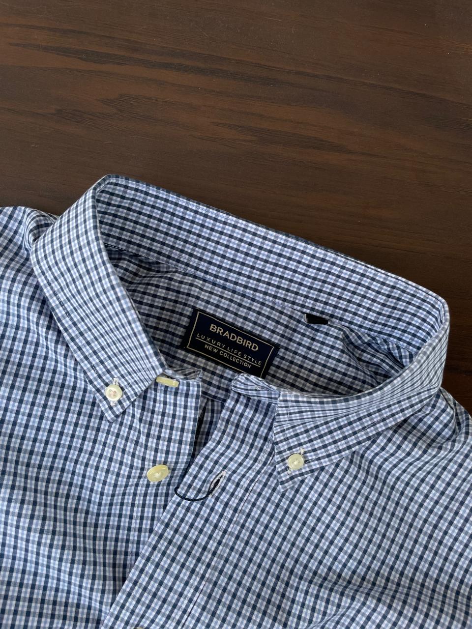 Sky blue micro-check shirt neckline with inner label and buttoned collar tips