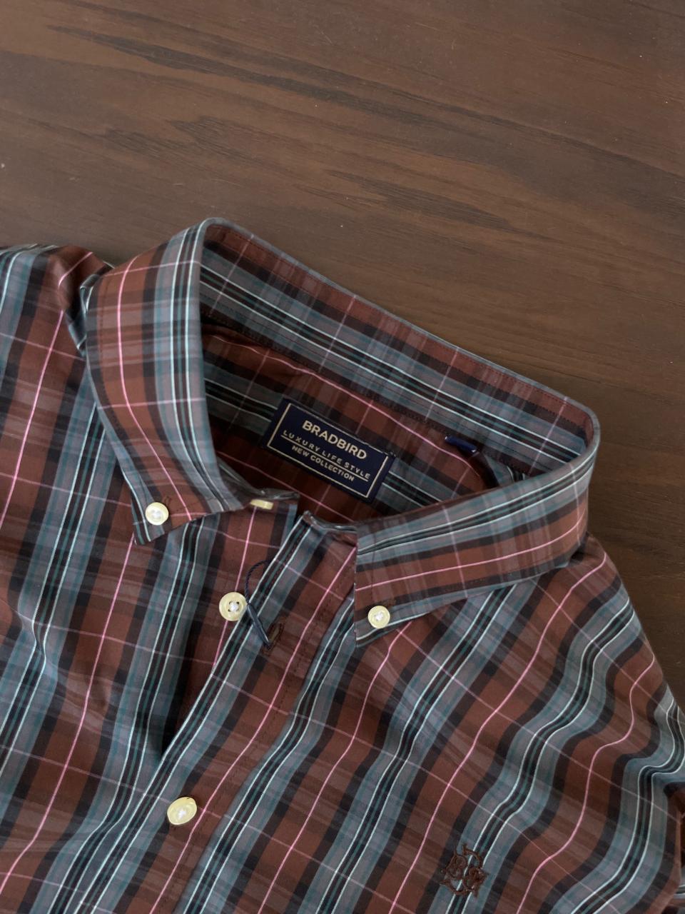 Tartan plaid button-up shirt collar and buttons, tan and slate grey color tones