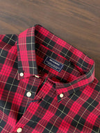 Red and black buffalo check shirt collar with inner label and white button details