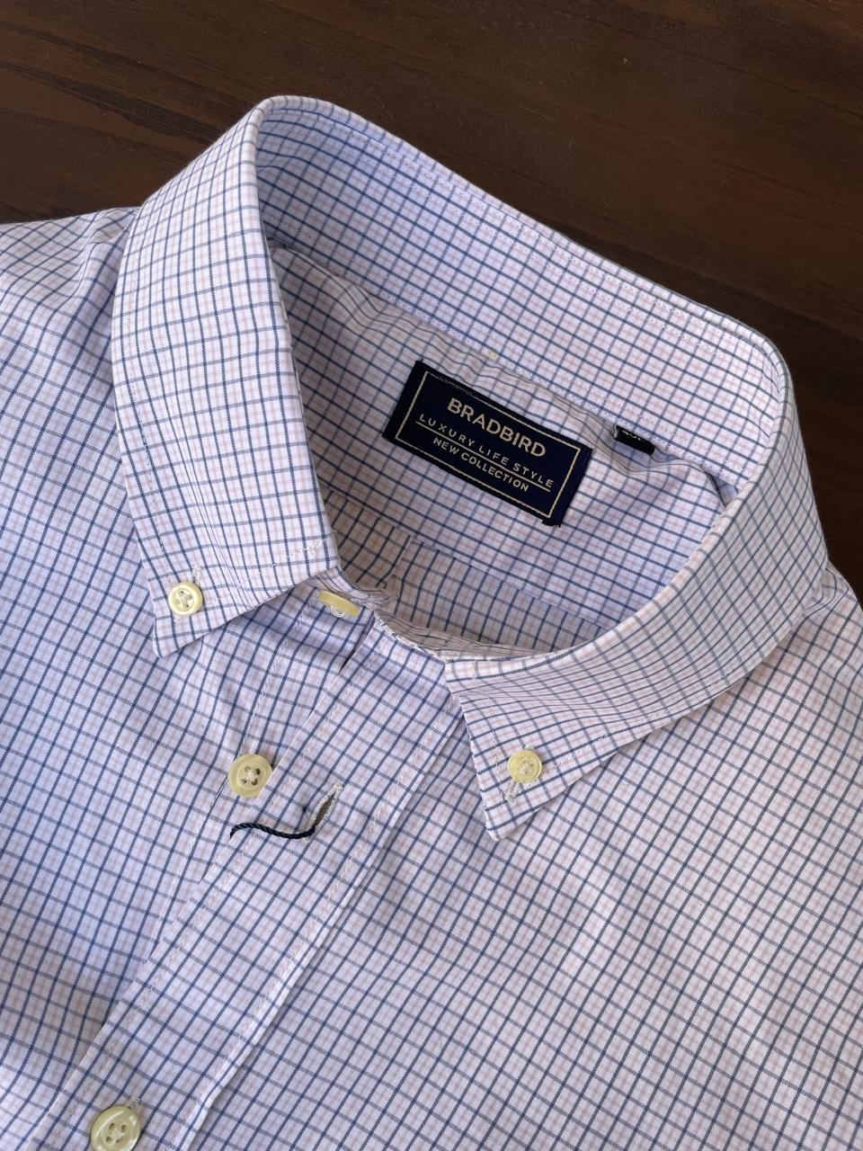 Light blue micro-check button-down shirt neckline and chest buttons with inner label