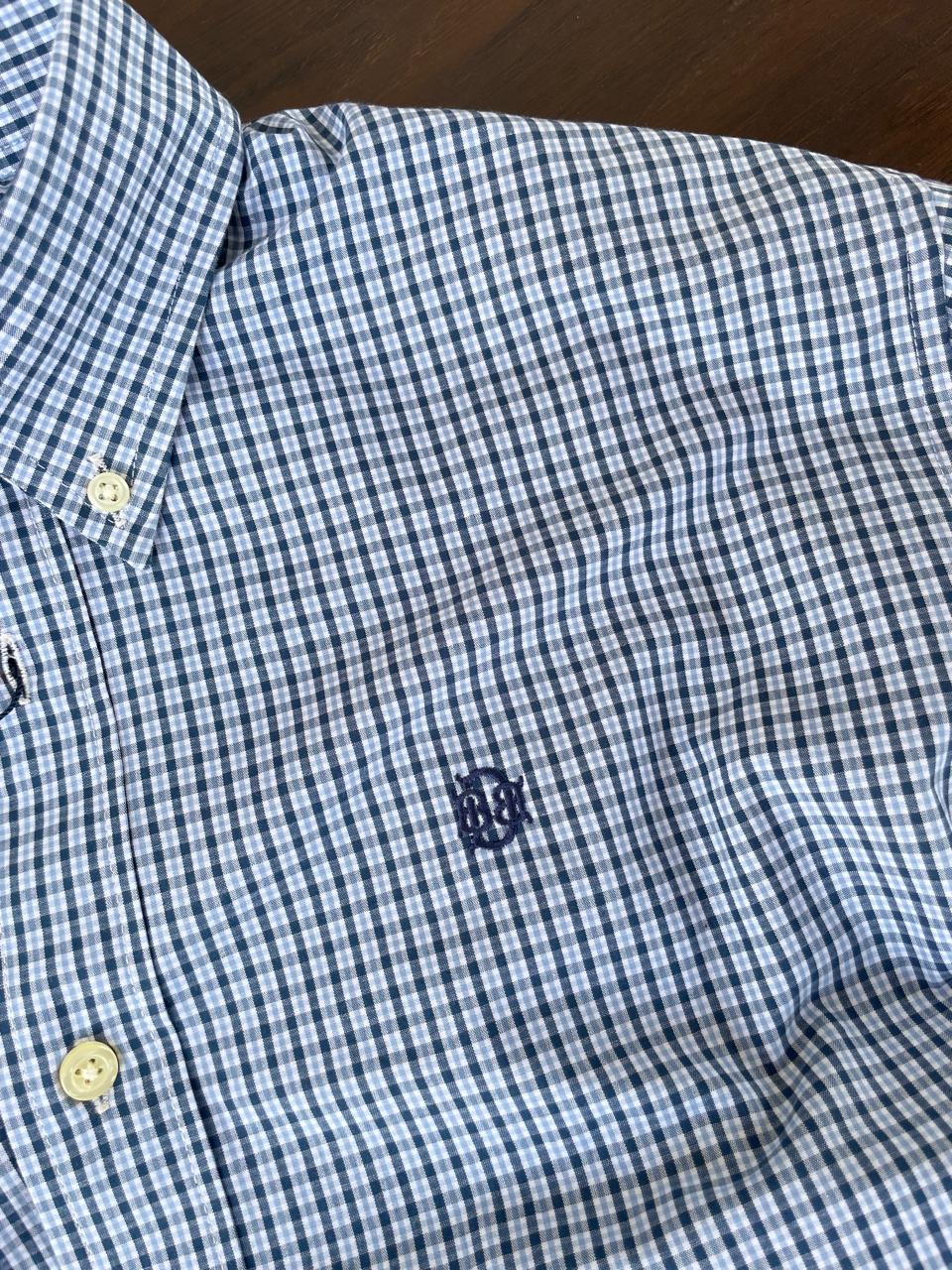 Sky blue micro-check shirt chest area with embroidered logo and buttoned placket