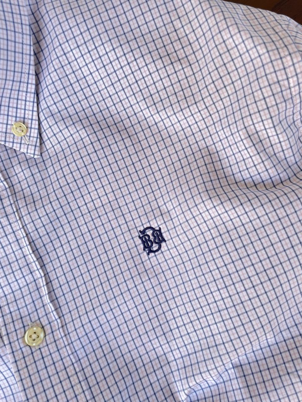Light blue micro-check shirt with navy-style chest emblem and yellowish buttons