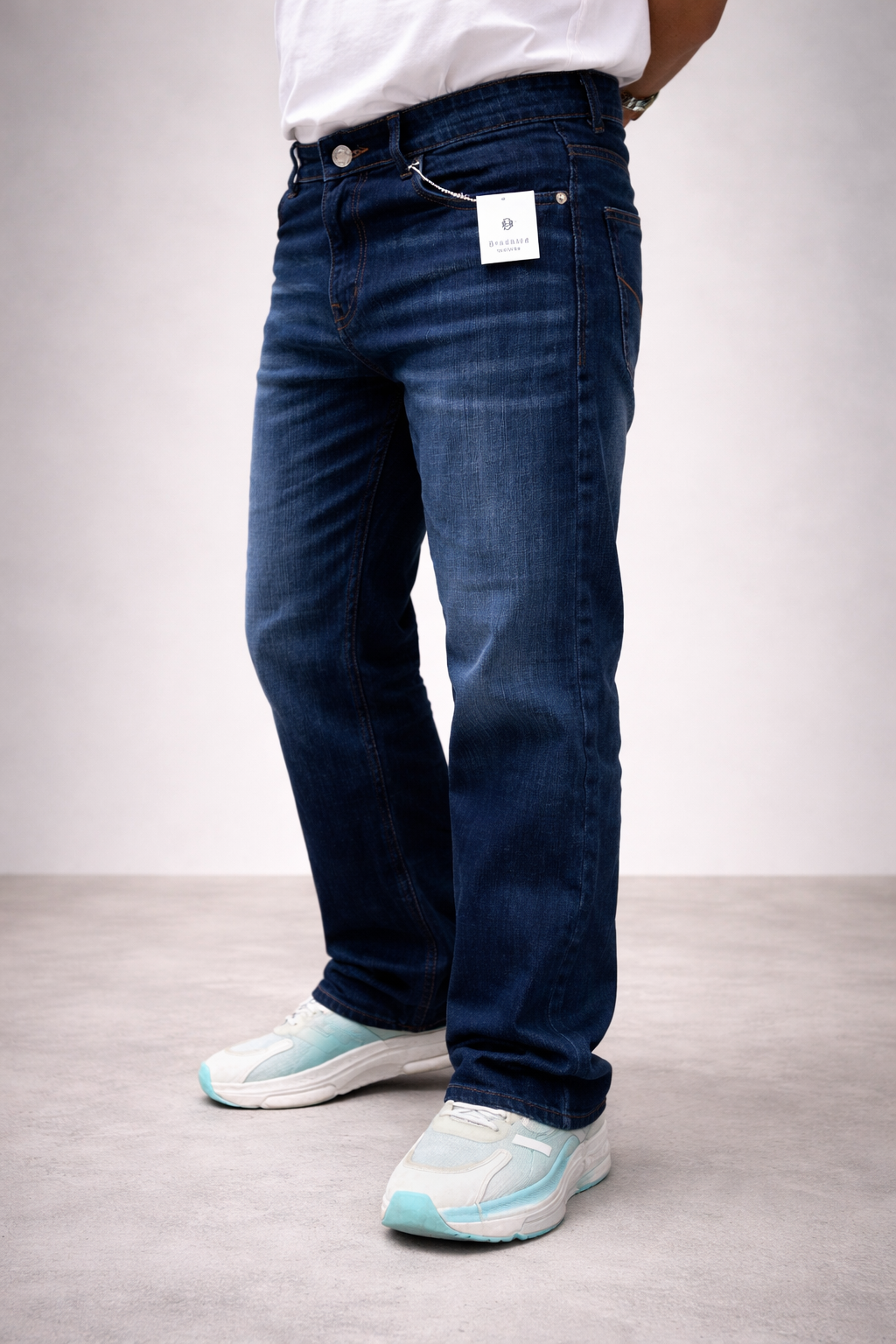 Back view of dark indigo straight-fit jeans with vintage wash and cuffed hem