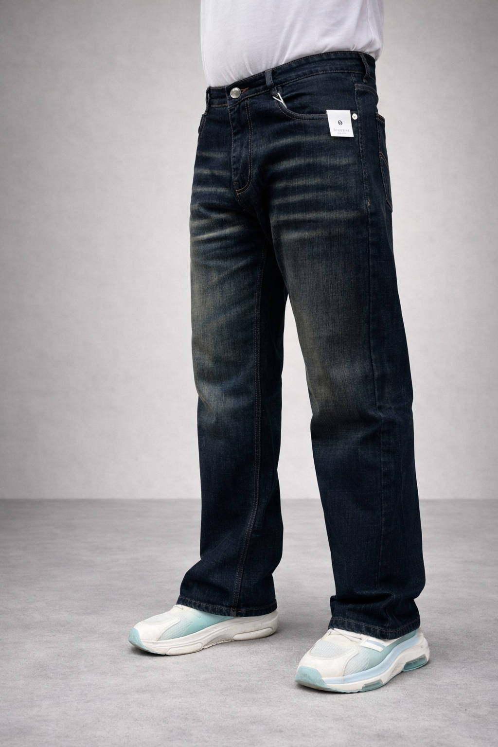 Dark indigo straight-fit jeans, back view: belt loops and roomy rear pocket seams.