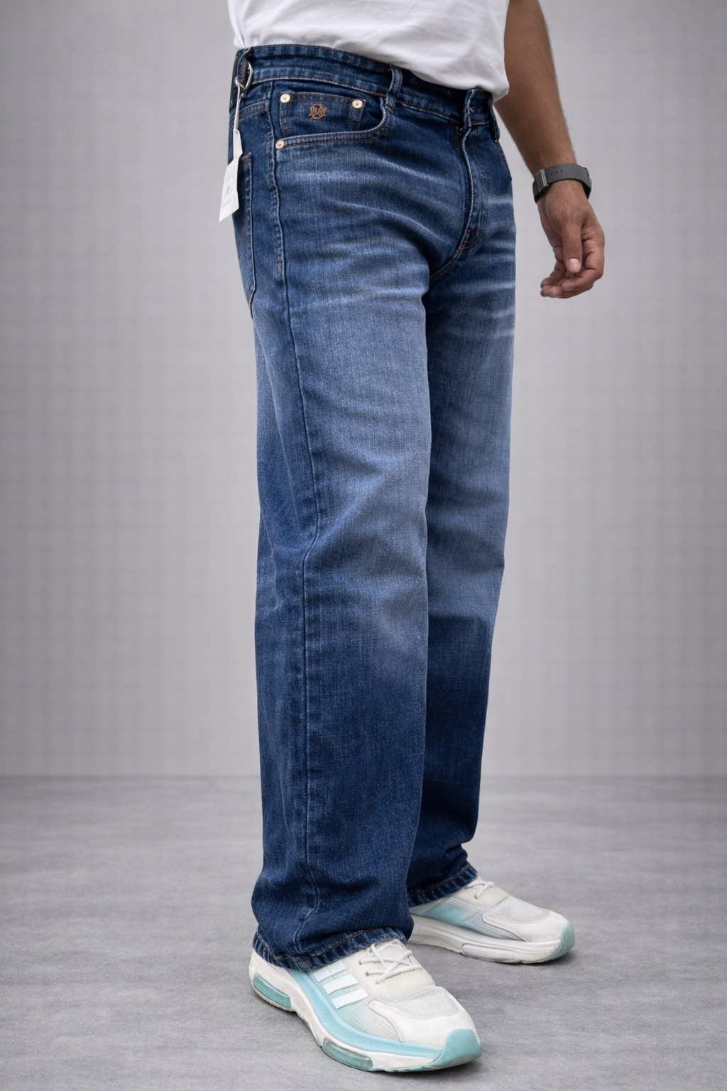 Indigo straight-fit jeans, back/side view with back yoke, belt loops, and cuffed hem.