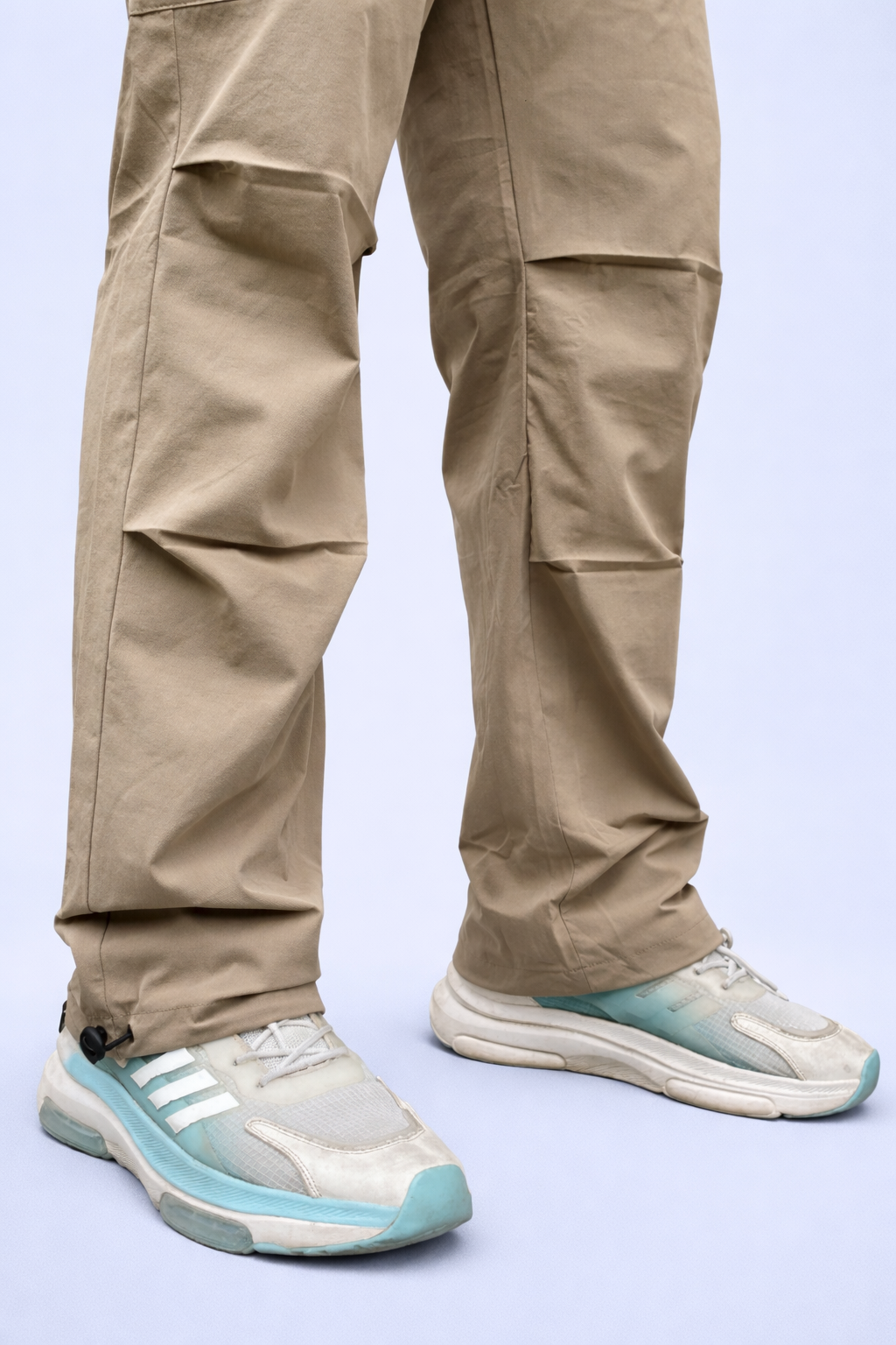 Beige cargo joggers with tapered legs and cargo pockets at the thighs