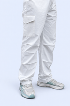 White cargo joggers with stacked cargo pockets at the leg and elastic ankle cuffs