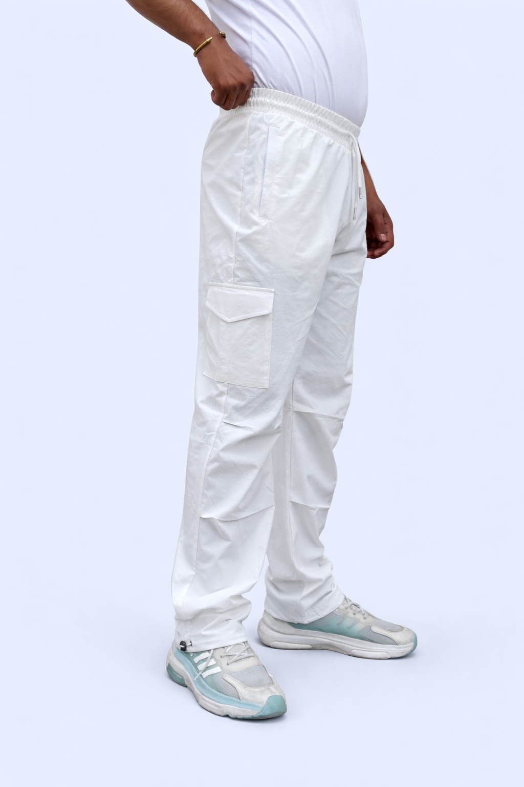 White cargo joggers side view with multiple cargo pockets and adjustable ankle cuff