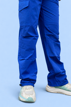 Blue cargo jogger pants back view with layered cargo panels and elastic cuffs