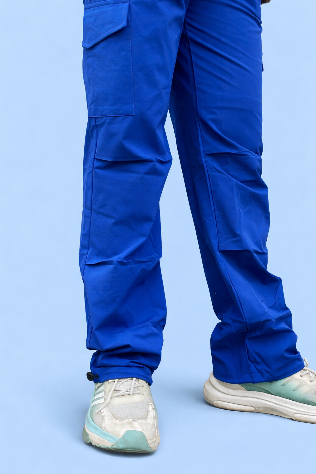 Blue cargo jogger pants back view with layered cargo panels and elastic cuffs