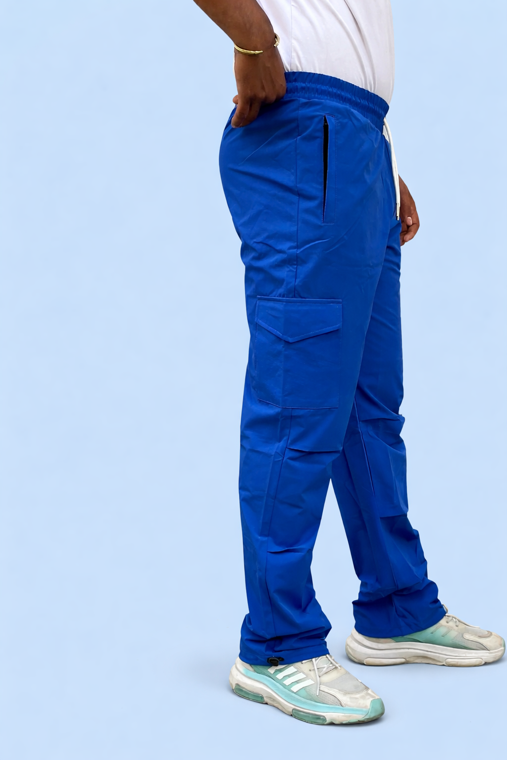 Blue cargo jogger pants side view with cargo pockets and elastic ankle cuff