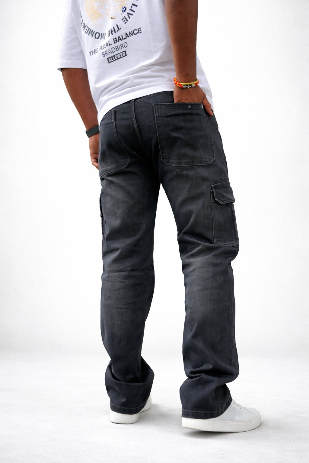 Men’s dark denim utility jeans with cargo pocket details on the outer thighs