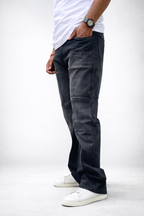 Charcoal grey utility cargo denim jeans, side view with large thigh patch pockets