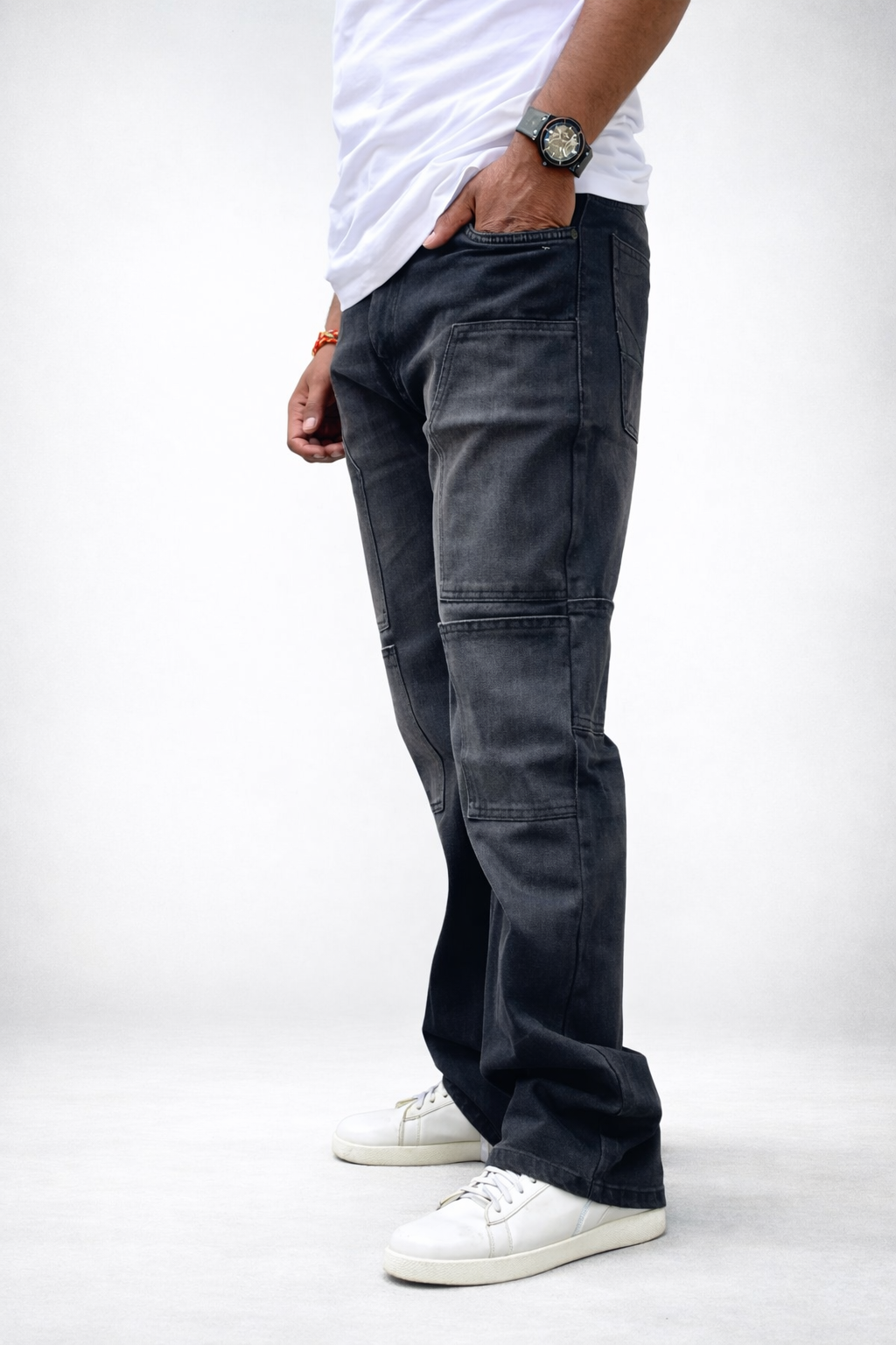 Charcoal grey utility cargo denim jeans, side view with large thigh patch pockets