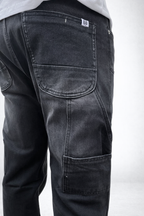 Charcoal grey carpenter jeans close-up of back pocket and leg cargo panel