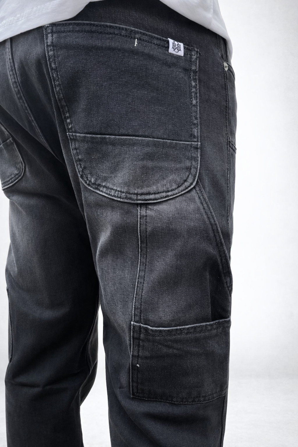 Charcoal grey carpenter jeans close-up of back pocket and leg cargo panel
