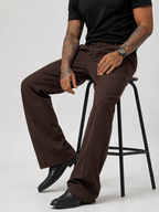 Men’s dark brown relaxed pants with front pleat, side pockets, and wide leg