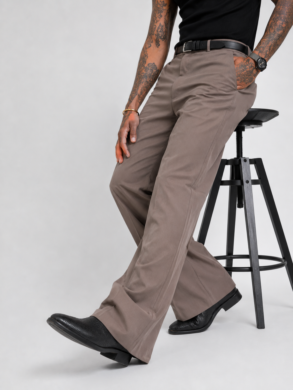 Muted khaki wide-leg pants with belt loops, front pockets, and stitched crease