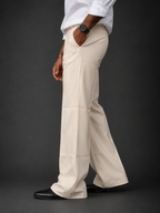 Ecru relaxed-fit structured pants, side profile with belt loops and flat front