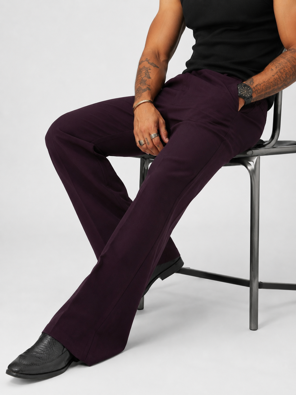 Dark wine violet relaxed-fit structured pants, seated view, button fly and pleats