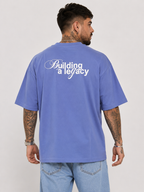 Lavender blue drop-shoulder tee with back print reading 'Building a legacy'
