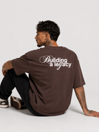 Cacao brown drop-shoulder tee with large "Building a legacy" back print