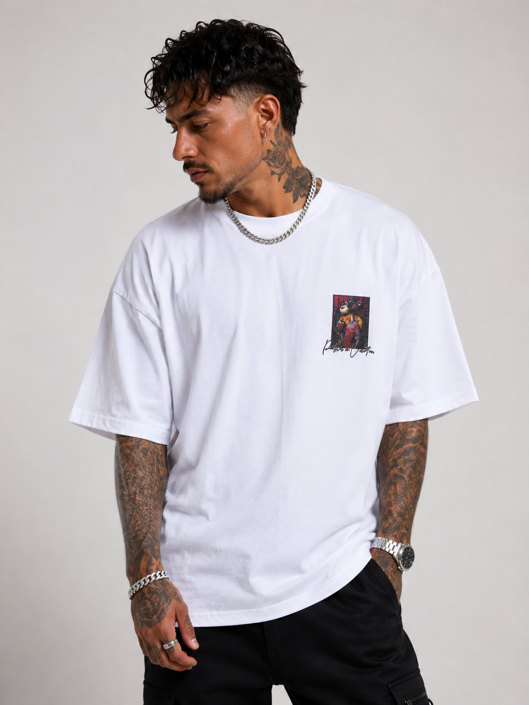 Off-white drop-shoulder tee with small chest artwork, short sleeves, crew neck