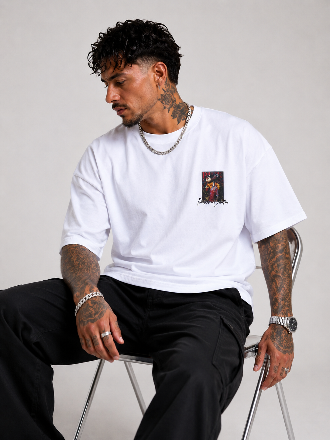 Off-white drop-shoulder tee with small front graphic patch, crew neck