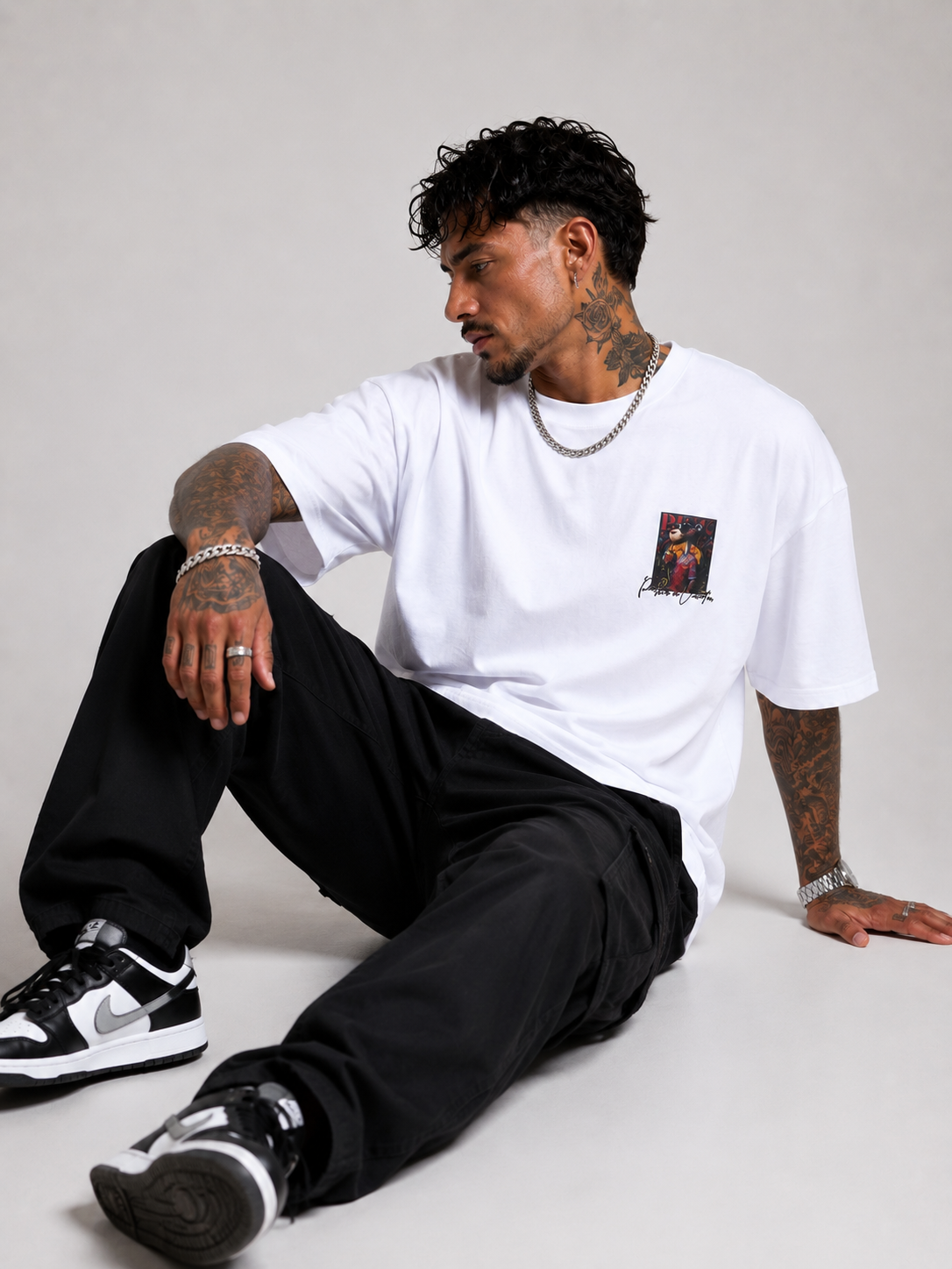 Off-white drop-shoulder tee with small front graphic, crew neck, short sleeves