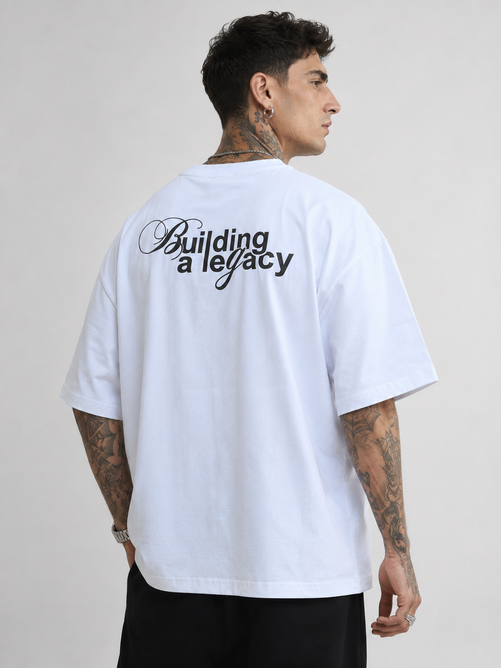 Off-white drop-shoulder T-shirt with "Building a legacy" back graphic