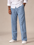 Light blue linen trousers, straight leg with functional side pockets and button waist