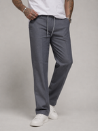 Dark grey linen trousers with drawstring waist and straight legs