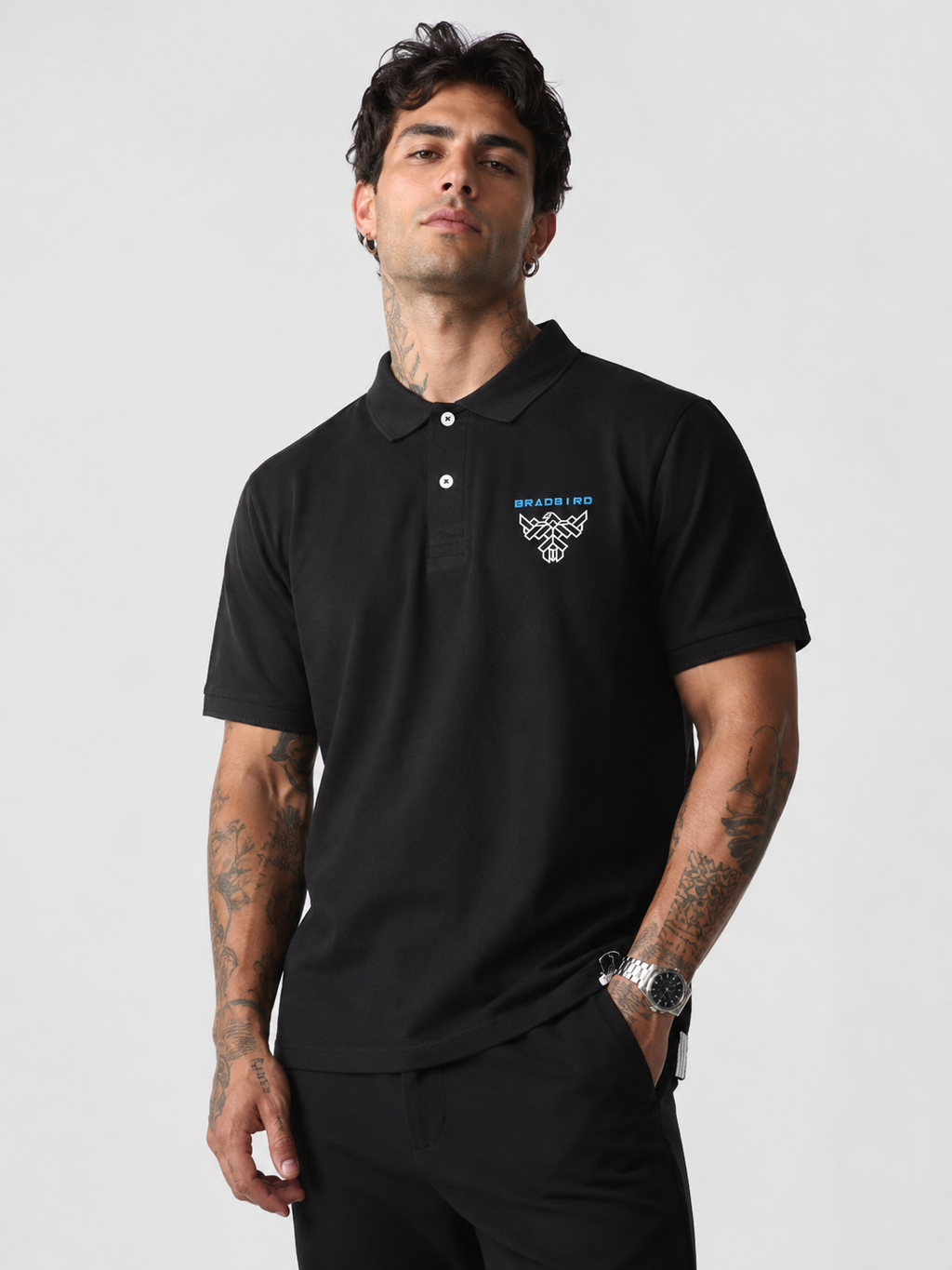 Black cotton polo shirt with ribbed collar, button placket, and chest logo