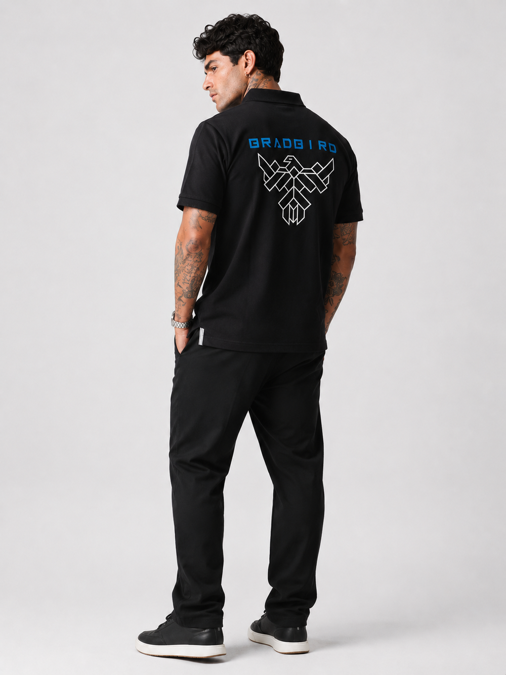 Black polo shirt back view with large geometric logo print and short sleeves