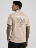 Tan beige cotton polo back view with large geometric logo graphic