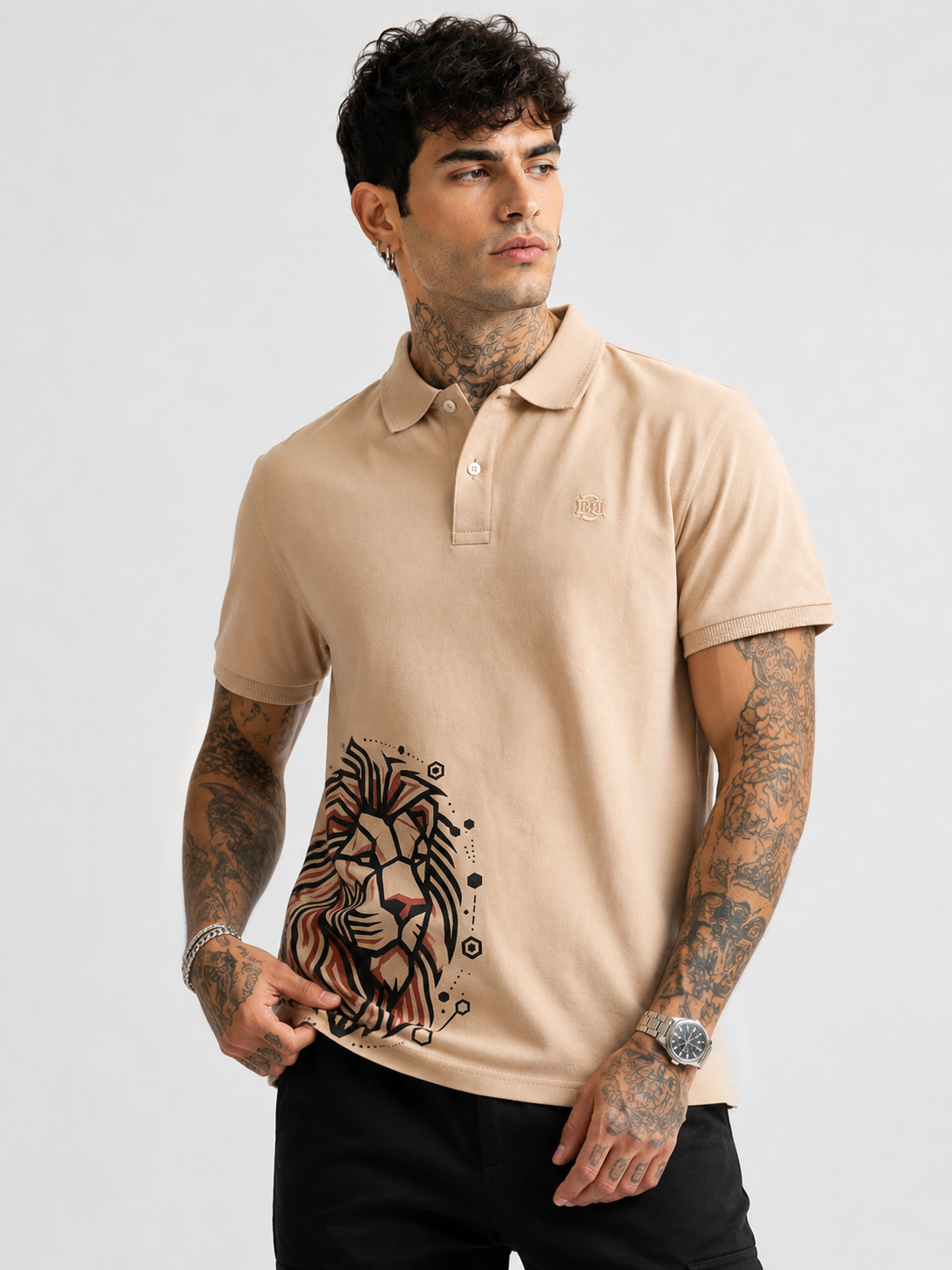 Beige polo shirt with lion graphic on front, short sleeves and button collar