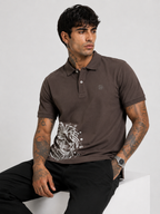 Brown polo T-shirt with button placket, chest logo, and white lion graphic