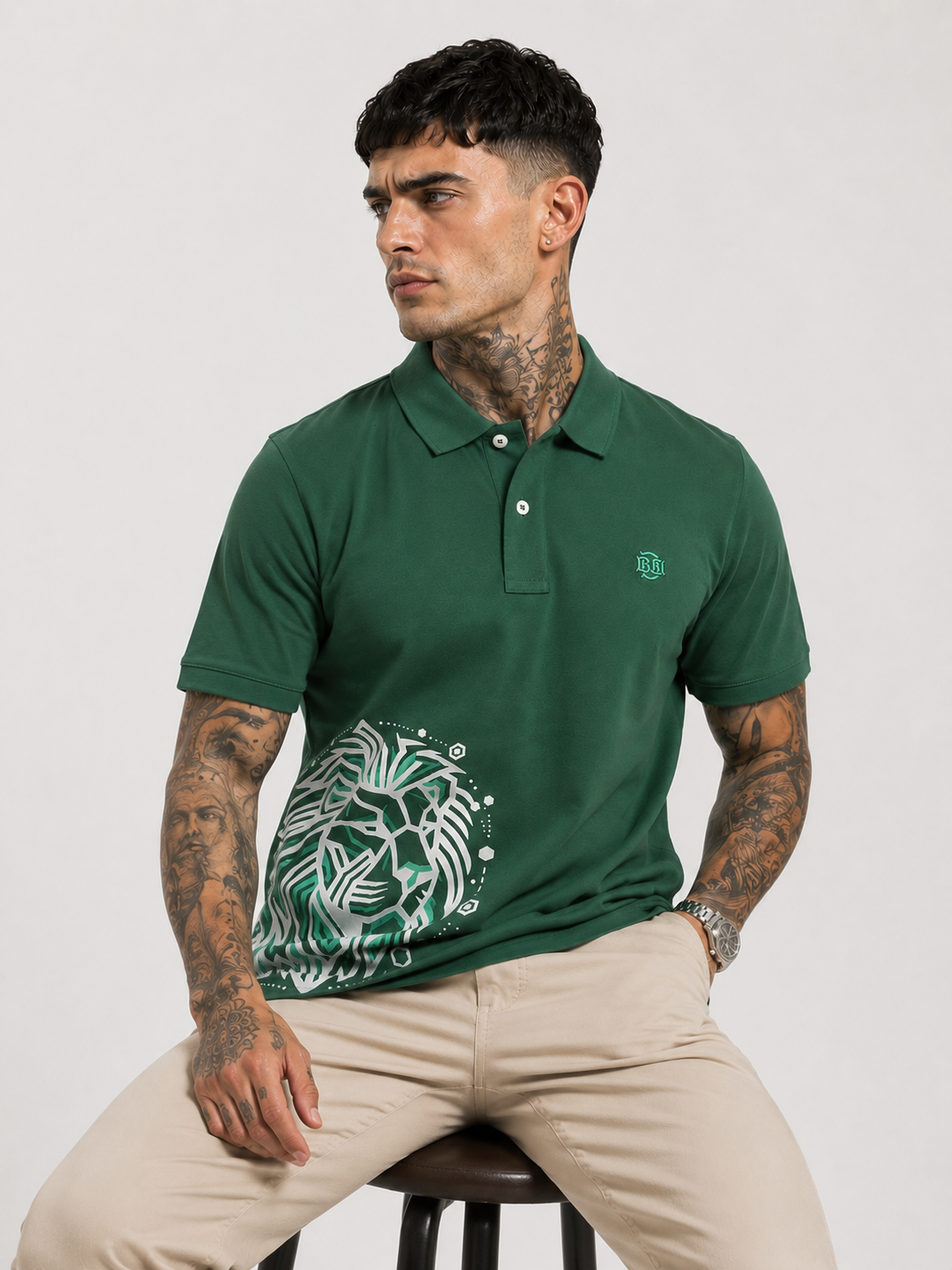 Green polo shirt with button placket and white lion graphic, small logo on left