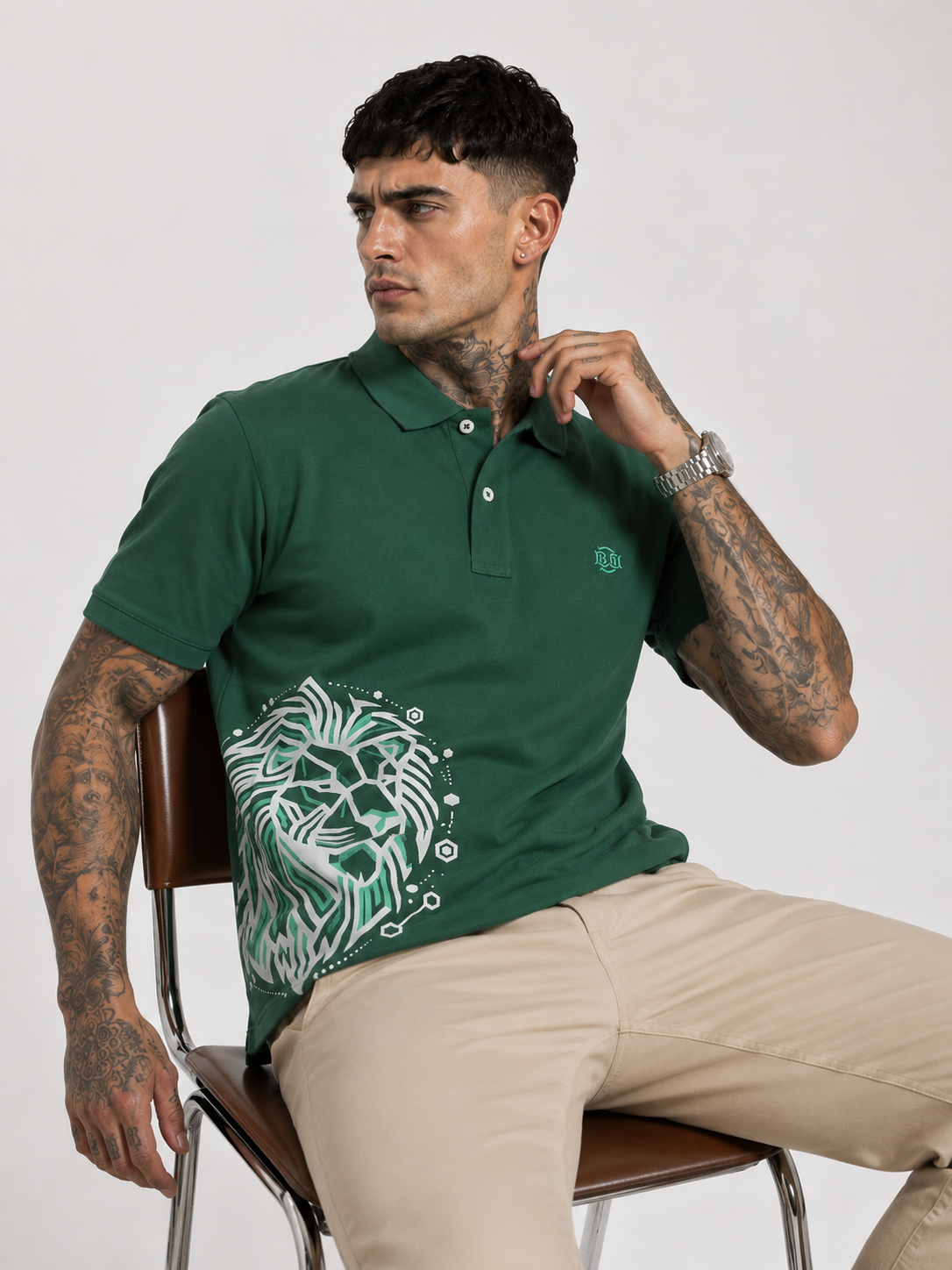 Green polo shirt with button placket and white lion graphic across chest