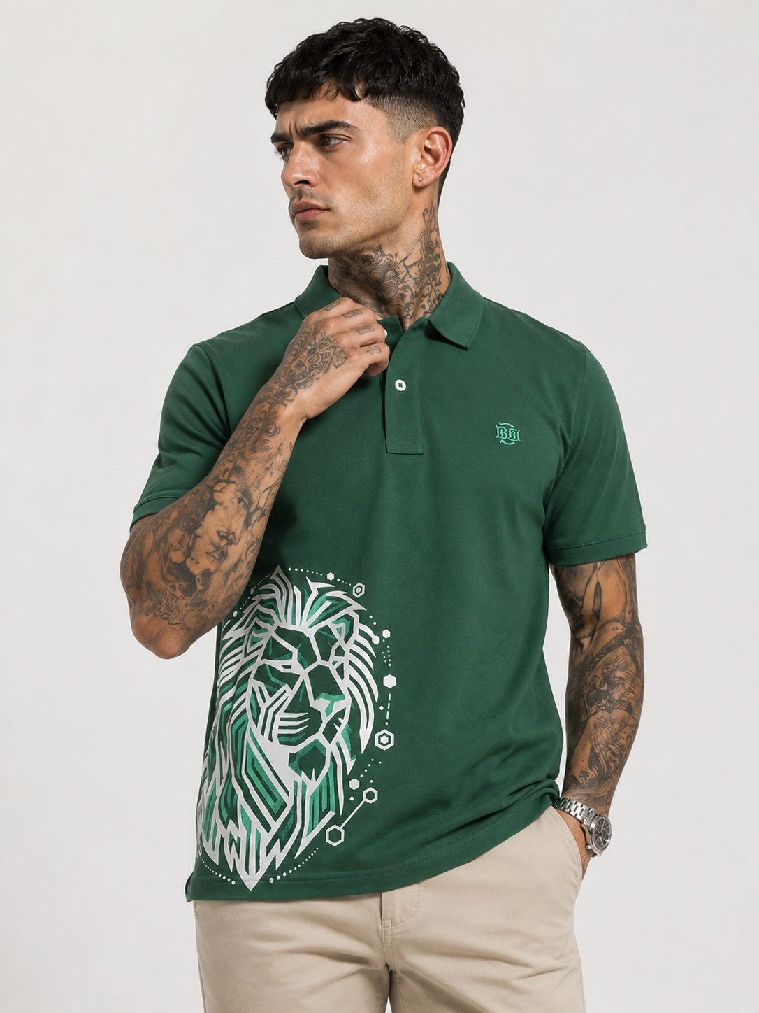 Green polo shirt with button placket, small chest logo, and white lion graphic