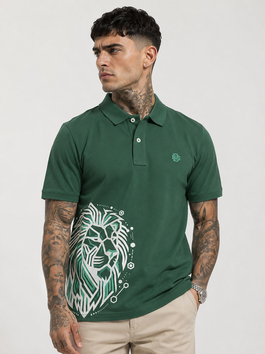 Green polo shirt with button placket and white lion graphic on chest